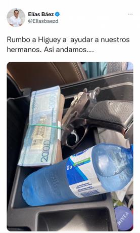 Con una pistola, un fajo de dinero y una botella de agua diputado “ayudará” a pobladores de Higüey